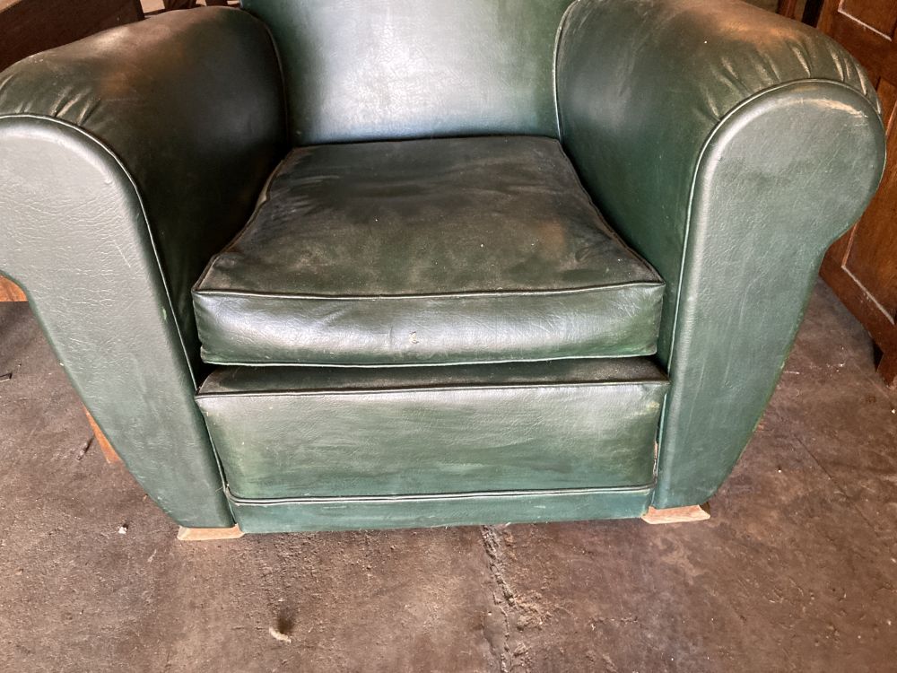 An Art Deco green leatherette armchair